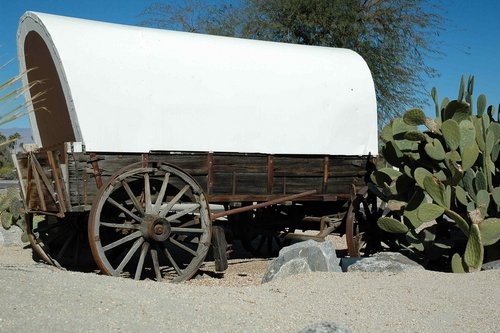 Covered wagon in New Mexico desert.