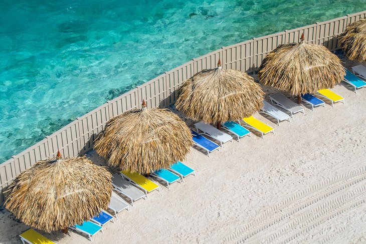 Beach cabanas and sun loungers on De Palm Island