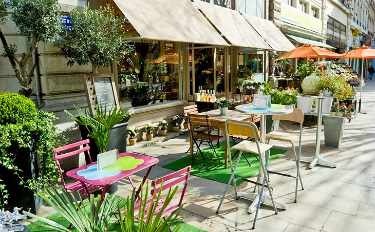 Outdoor seating at a "Bouchon Lyonnais" restaurant in Lyon