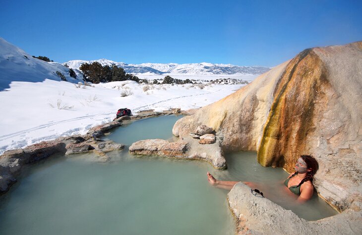 Woman soaking in a natural hot spring in California