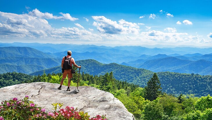 A hiker enjoying the view over the Smoky Mountains from the Blue Ridge Parkway in North Carolina