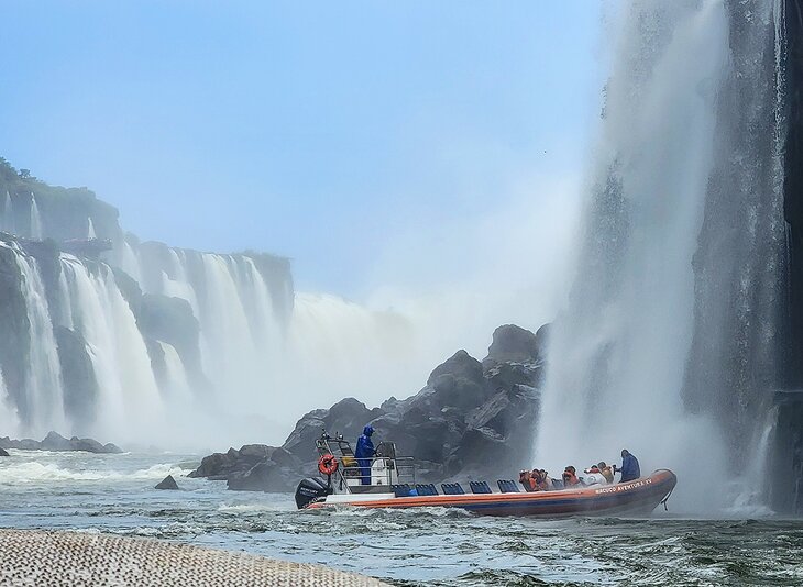 Guests getting soaked below the falls on the wet boat tour of Iguaçu Falls