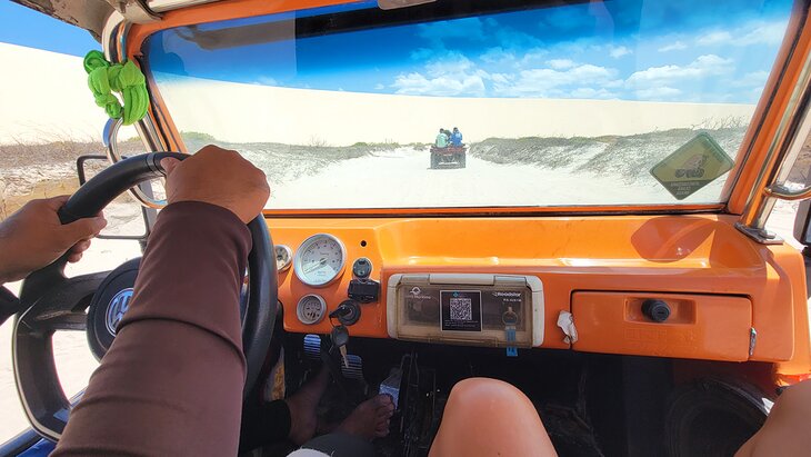 View through the front window of a buggy and a sand dunes tour